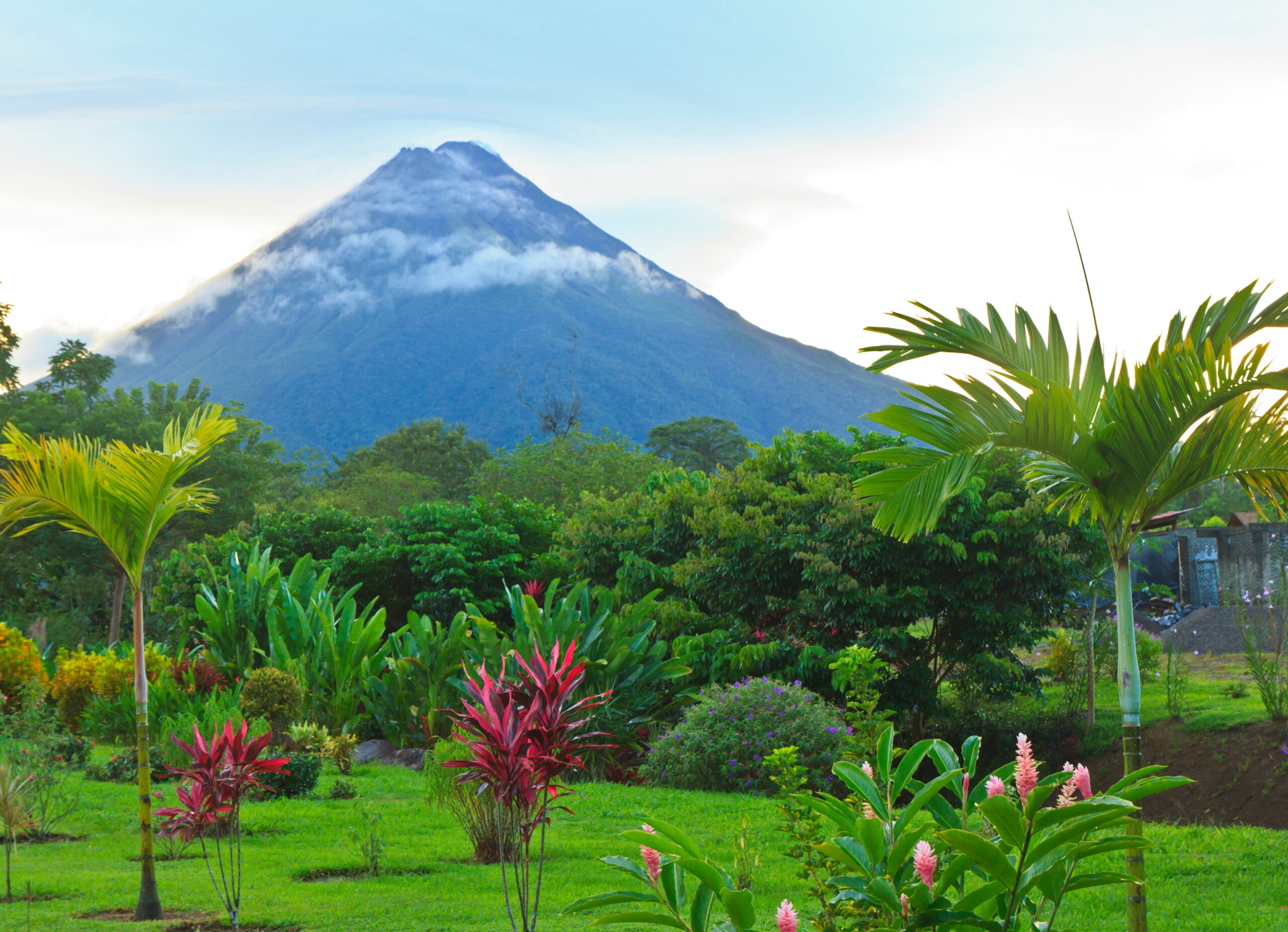 A lush garden in La Fortuna, Costa Rica with Arenal Volcano in the background