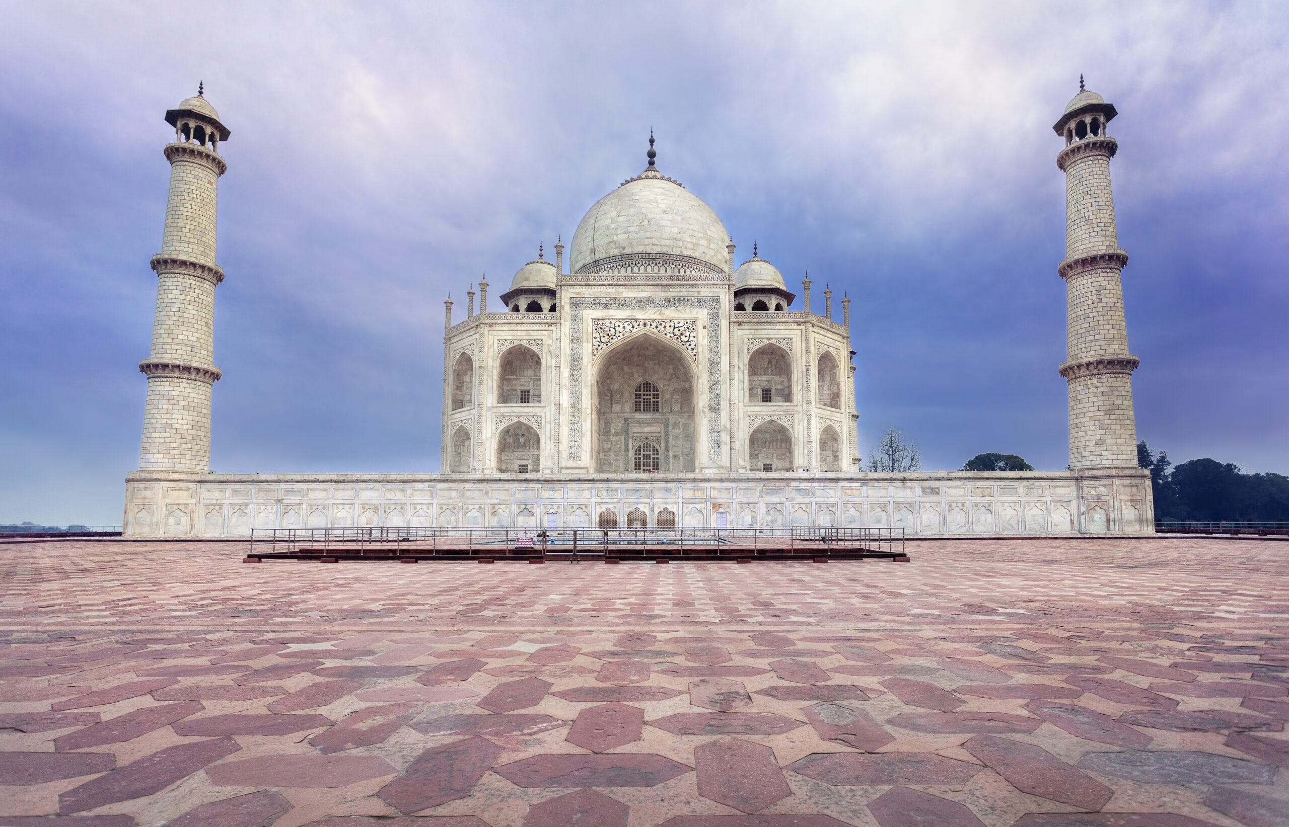 Taj Mahal tomb from white marble at blue dramatic sky in Agra, Uttar Pradesh, India